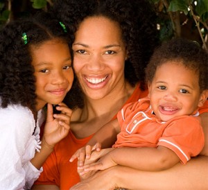 Black woman with her children, a young girl and boy todler