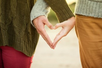 People holding hands in shape of heart