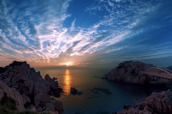 Sunrise and water, cliffs and a bridge