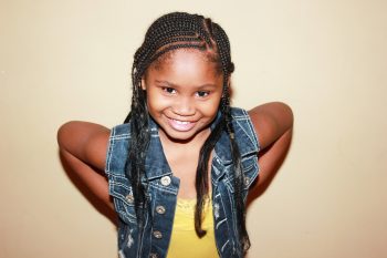 girl with hands on hips and smiling