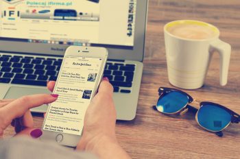 Woman's hands scrolling news on Iphone