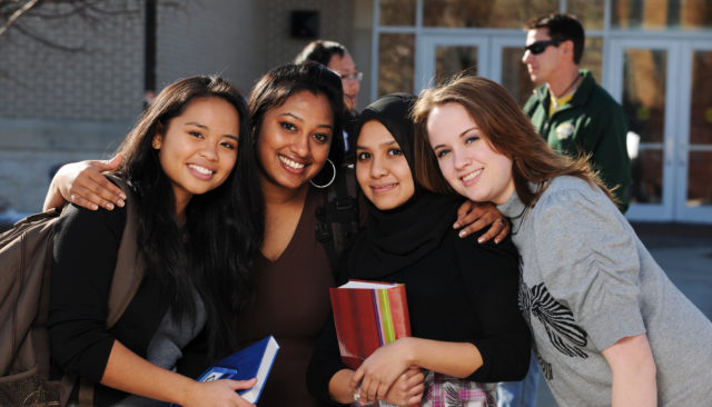 Group of diverse college students posing for photograph